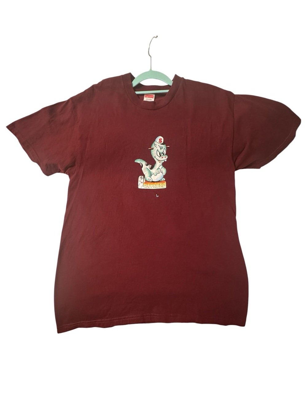 Supreme burgundy tee with dinosaur cartoon